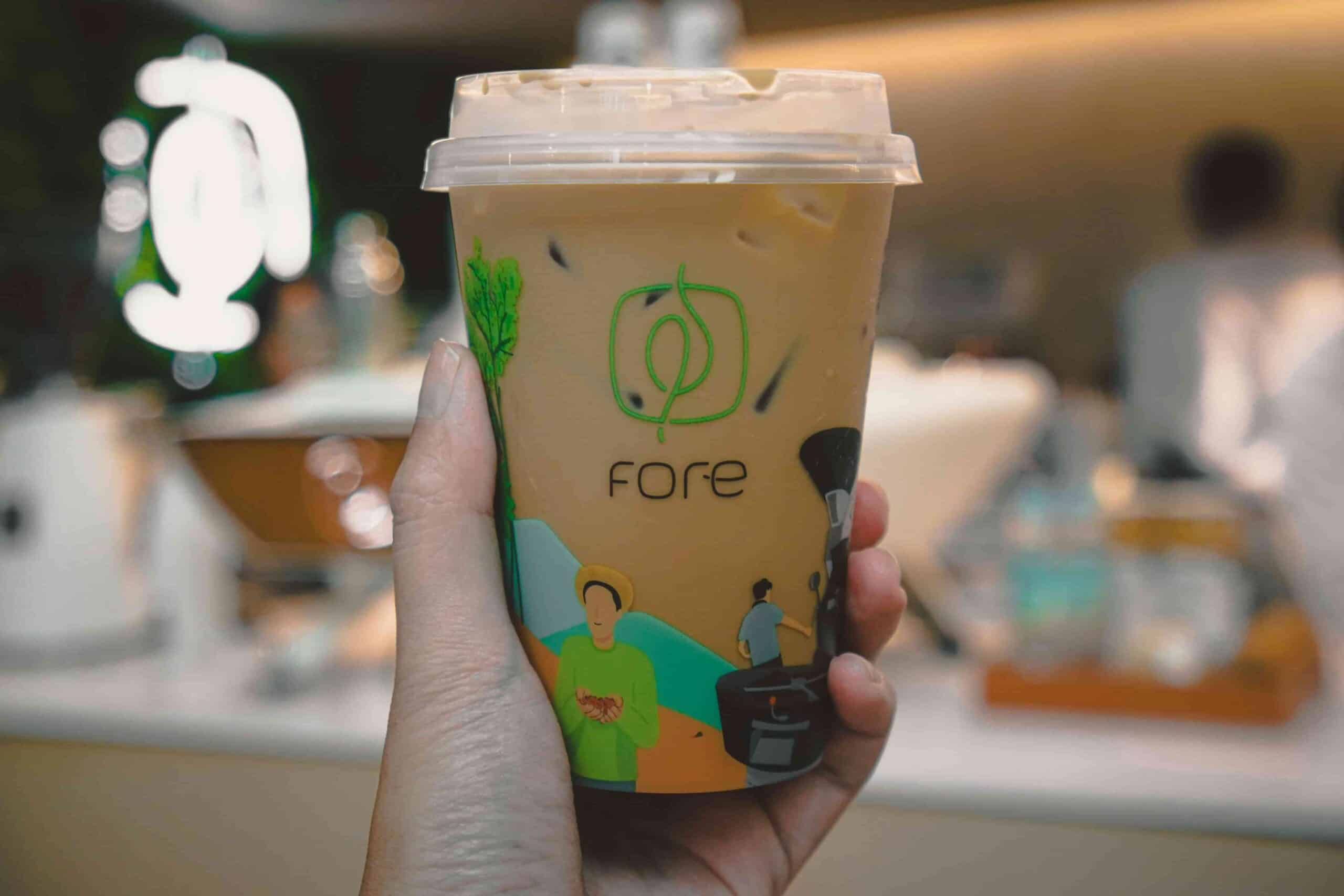 Can Caffeine Cause a Toothache or Gum Pain? 4 hand holding a fresh cup of cold brew coffee