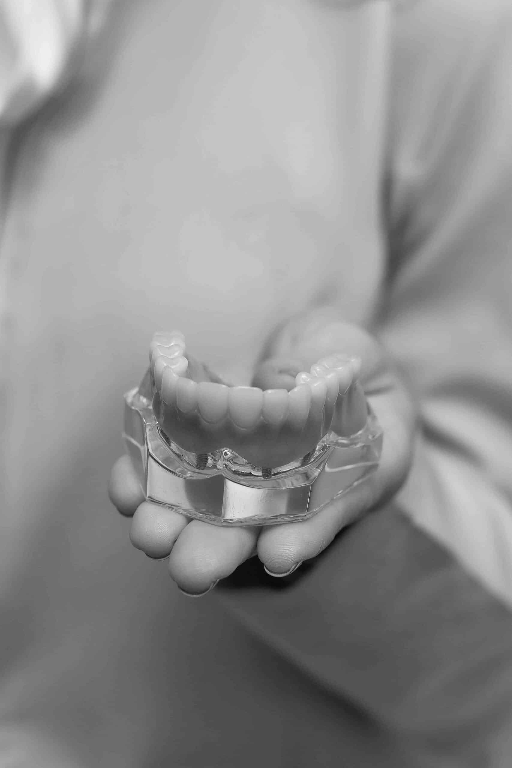 What ADA Data Reveals About the Future of Dentistry 5 black and white photo of dentist holding model teeth