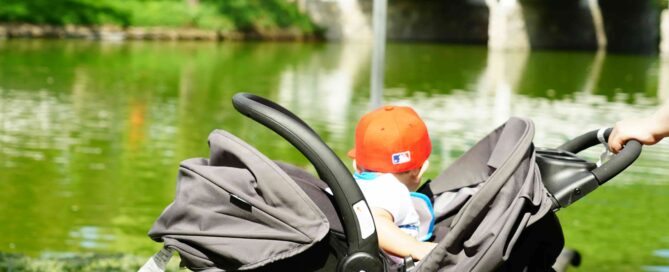 kid in stroller at park